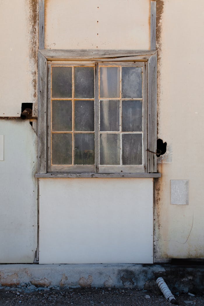 gallery-2 Old wooden window on white wall of shabby rustic house located in suburban district on sunny day